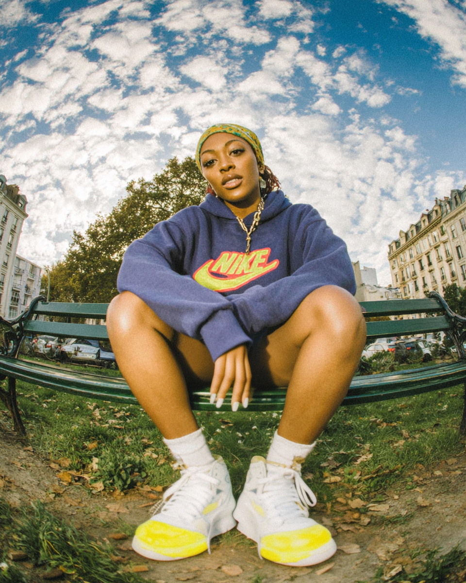 potatoad.studio_a_black_woman_wearing_a_purple_Nike_hoodie_an_5410caf6-8d17-44c6-a40f-fc6a82cbd59e_3